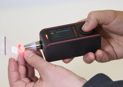 Close-up of miniRaman spectrometer laser measurement on sample