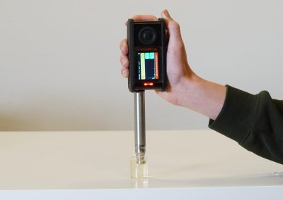 Handheld Raman spectrometer device with probe attachment