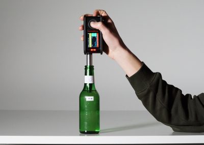 Handheld miniRaman spectrometer testing beverage bottle for content verification
